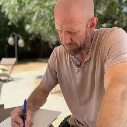 Sam Morris writing outdoors